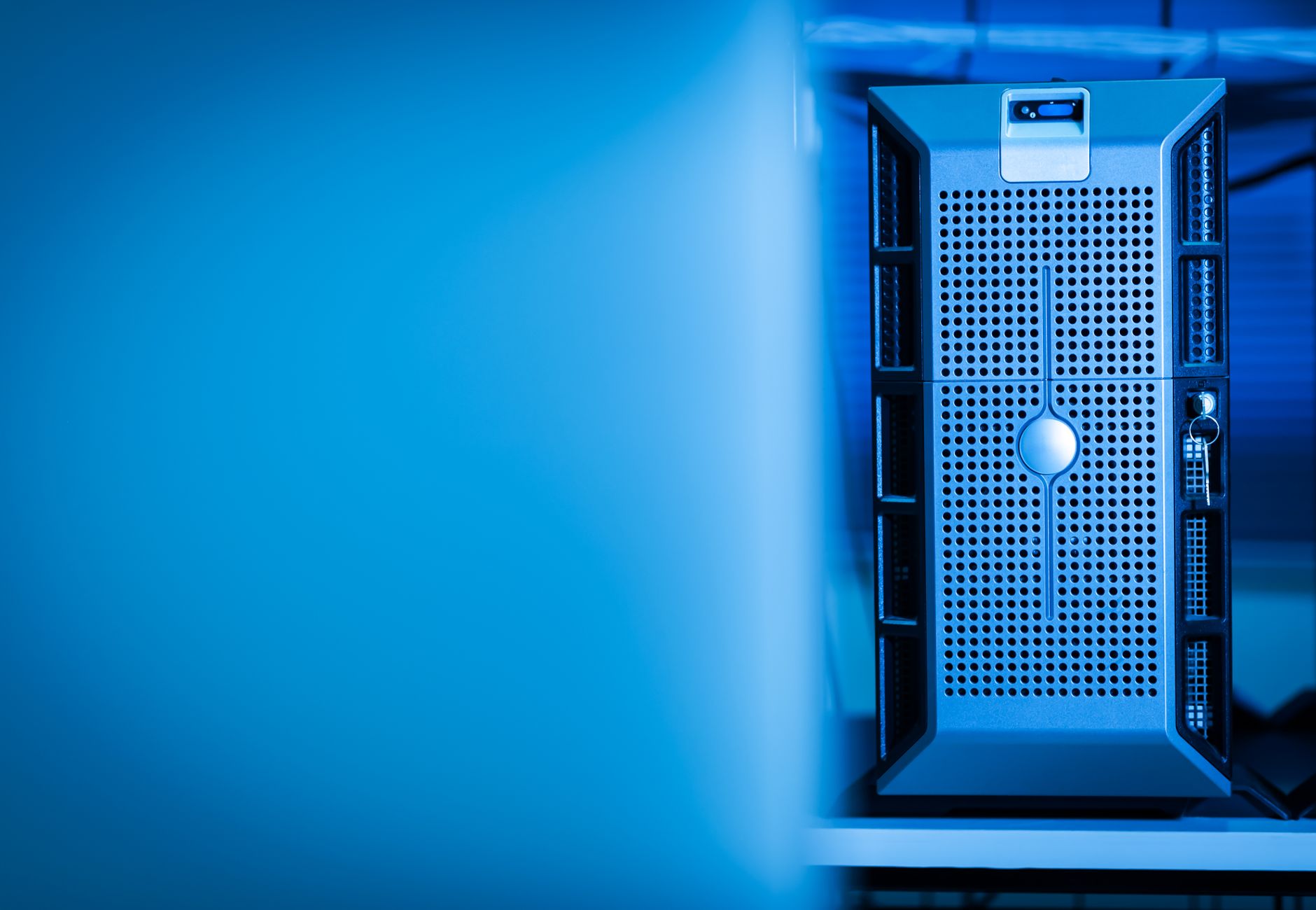 Close-up of a modern server unit in a blue-lit data center environment.